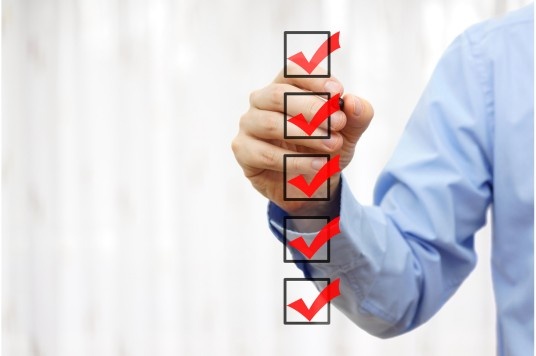 Small business owner reviewing a daily marketing checklist to follow key digital marketing tips India for growth.